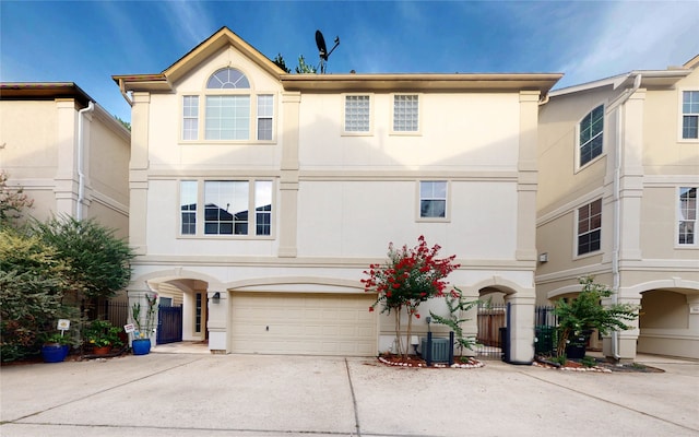 view of front of property with central AC unit and a garage