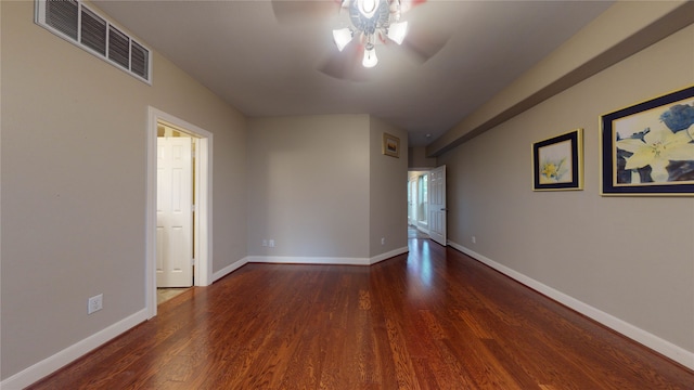 spare room with ceiling fan and dark hardwood / wood-style flooring