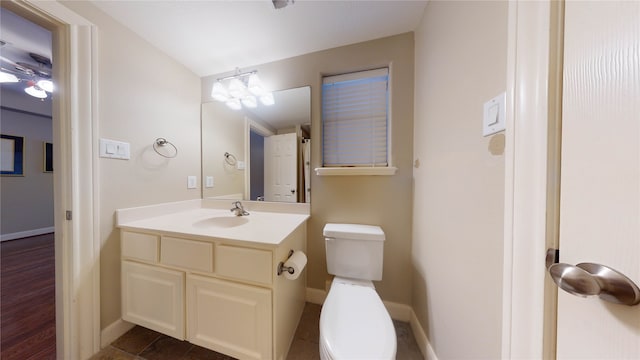 bathroom featuring a chandelier, hardwood / wood-style floors, vanity, and toilet