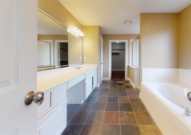 bathroom featuring vanity and a tub