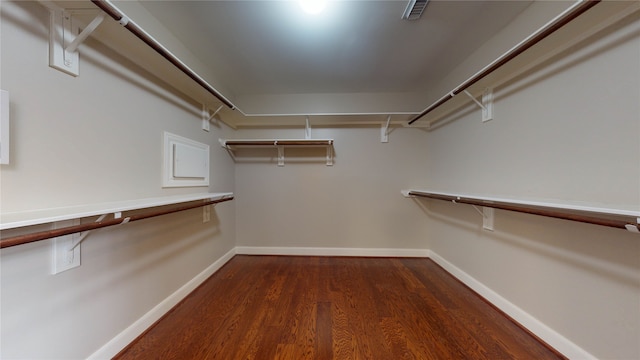 spacious closet featuring dark wood-type flooring