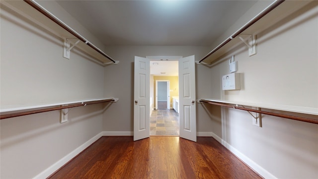 spacious closet with dark wood-type flooring