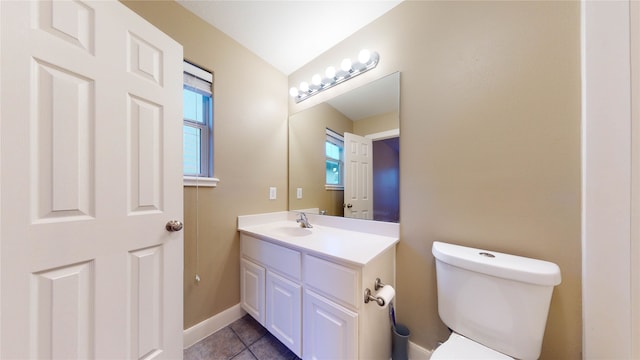 bathroom with tile patterned flooring, vanity, and toilet