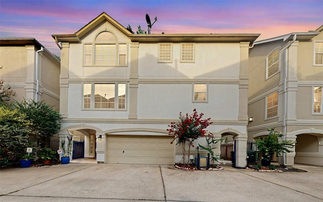 view of front of property featuring cooling unit and a garage