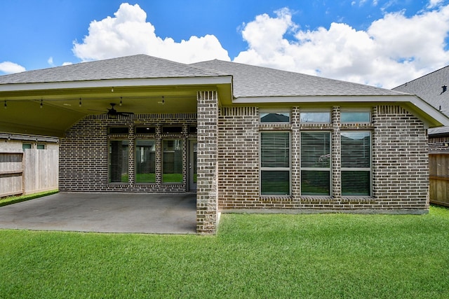 rear view of property with a patio, ceiling fan, and a lawn