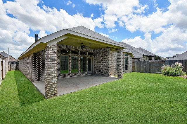 back of house featuring a yard, ceiling fan, and a patio area