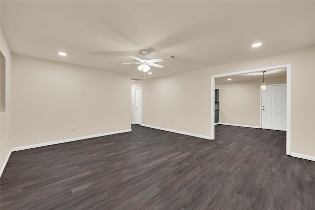 spare room with dark hardwood / wood-style flooring and ceiling fan