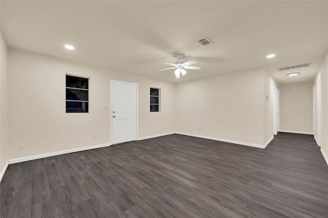 spare room with ceiling fan and dark hardwood / wood-style flooring