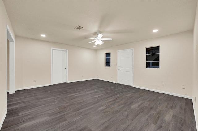 spare room with dark hardwood / wood-style floors and ceiling fan