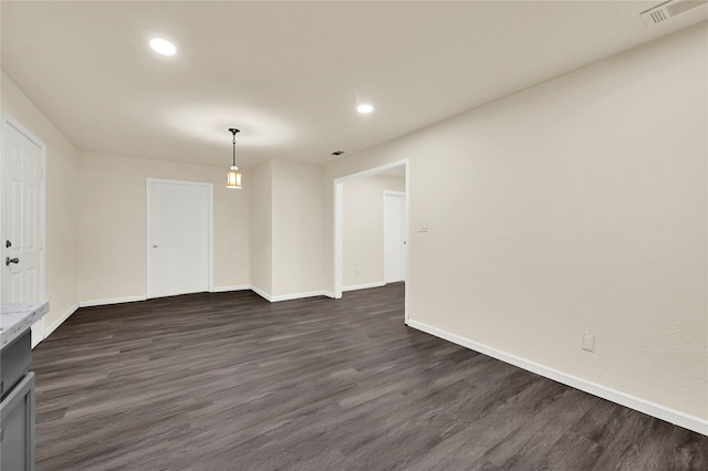 spare room with dark hardwood / wood-style floors