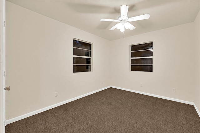 carpeted empty room featuring ceiling fan and built in features