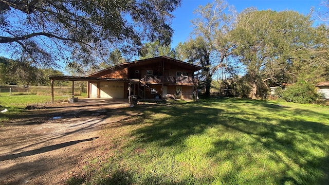 exterior space featuring a carport, a garage, a front lawn, and a wooden deck