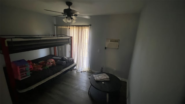 bedroom featuring a wall mounted AC, ceiling fan, and dark hardwood / wood-style floors