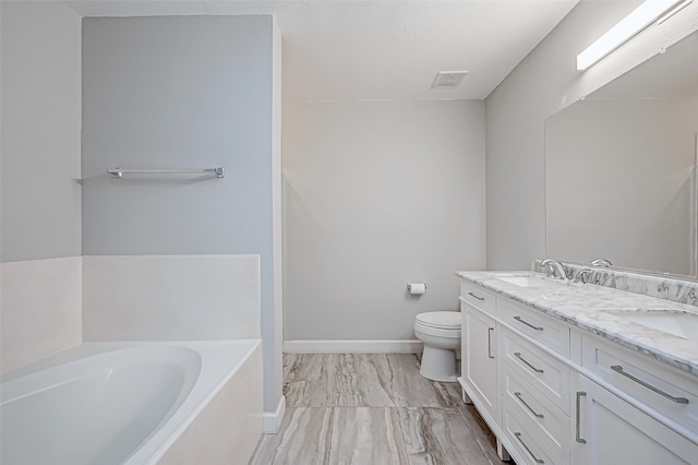 bathroom featuring a bath, vanity, and toilet