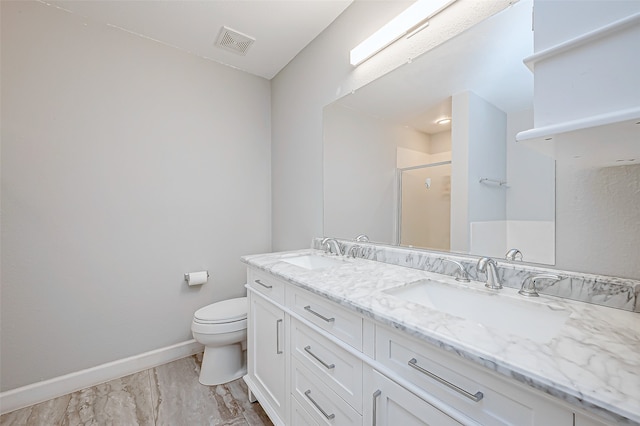 bathroom featuring vanity, toilet, a shower with door, and wood-type flooring