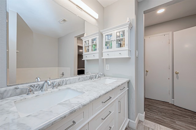 bathroom with vanity and hardwood / wood-style flooring