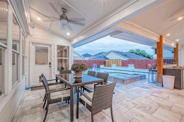 view of patio with ceiling fan and a pool with hot tub