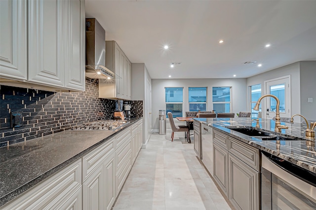 kitchen with sink, wall chimney exhaust hood, tasteful backsplash, stainless steel appliances, and beverage cooler