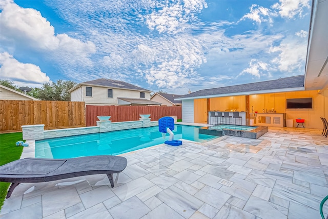 view of pool featuring a patio area and an in ground hot tub