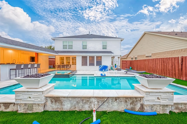 view of pool featuring a bar and an in ground hot tub