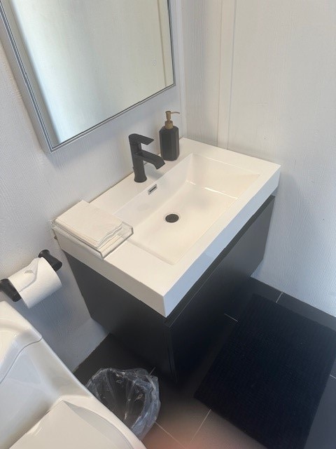 bathroom with tile patterned flooring and sink