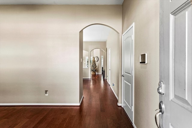 hallway with dark hardwood / wood-style flooring