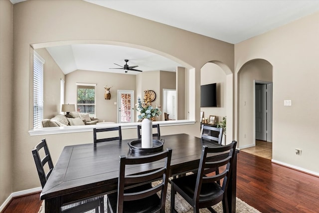 dining area with hardwood / wood-style floors, ceiling fan, and vaulted ceiling