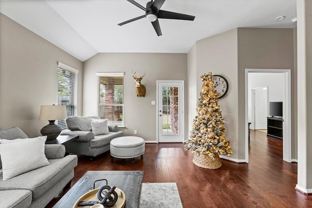 living room featuring vaulted ceiling, ceiling fan, and dark hardwood / wood-style floors