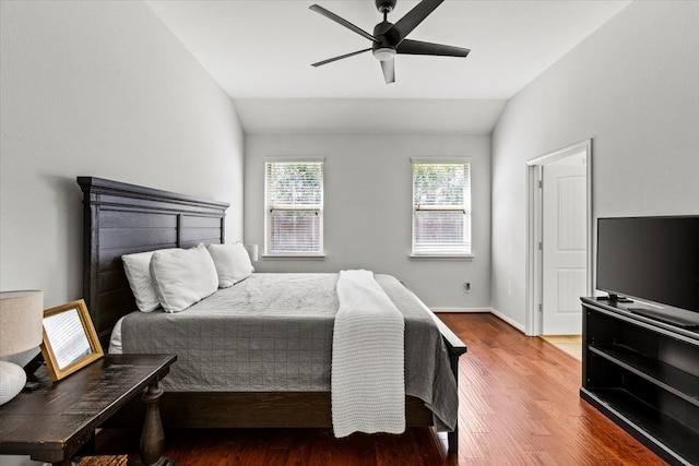 bedroom featuring ceiling fan, wood-type flooring, and lofted ceiling