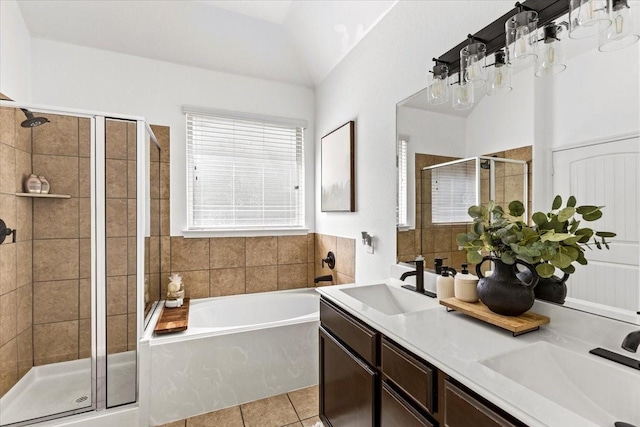 bathroom with tile patterned flooring, vanity, lofted ceiling, and plus walk in shower