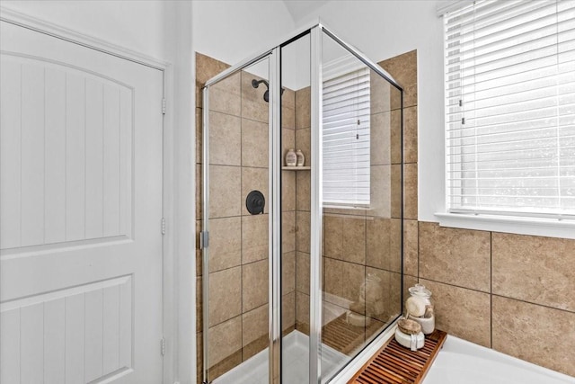 bathroom with a shower with door