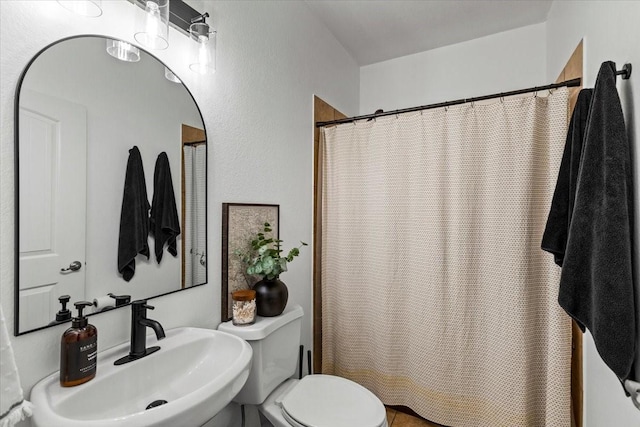 bathroom featuring toilet and sink