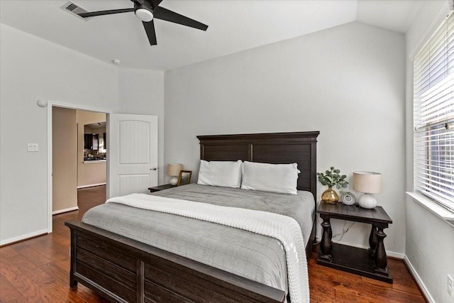 bedroom featuring ceiling fan, dark hardwood / wood-style floors, and vaulted ceiling