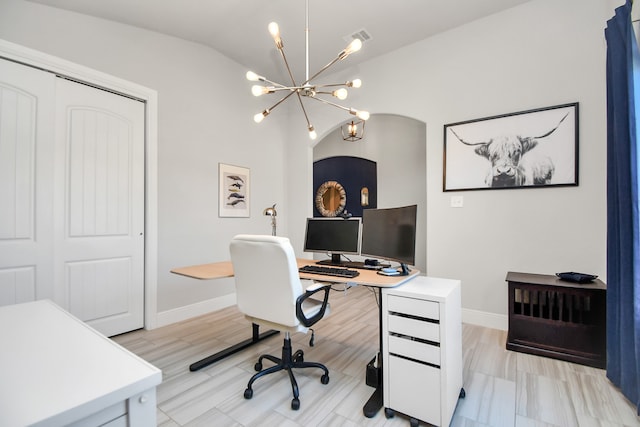 office space featuring lofted ceiling, light hardwood / wood-style flooring, and a notable chandelier