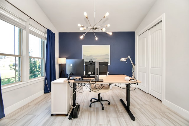 office area with a notable chandelier and vaulted ceiling