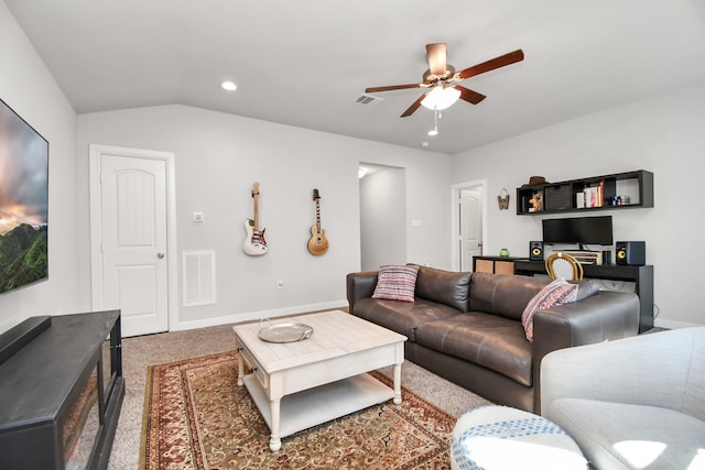 living room with carpet floors, ceiling fan, and lofted ceiling