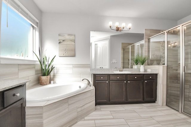 bathroom with vanity, a chandelier, and shower with separate bathtub