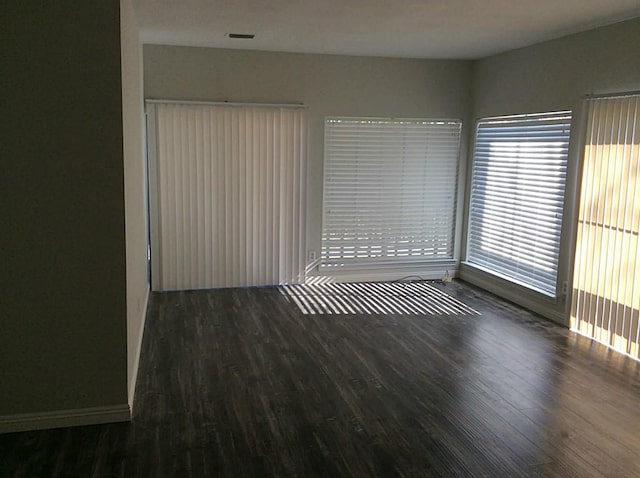 spare room with dark hardwood / wood-style floors