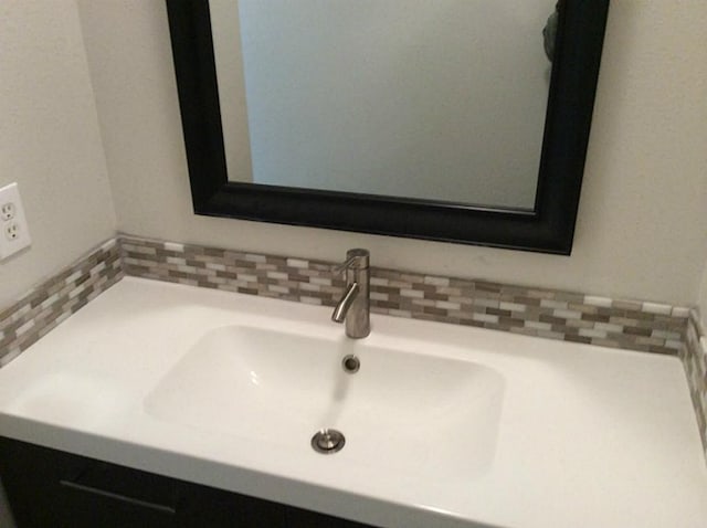 interior space with decorative backsplash and vanity