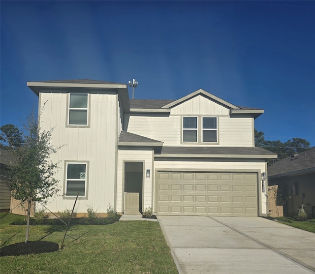 view of front facade featuring a front yard and a garage