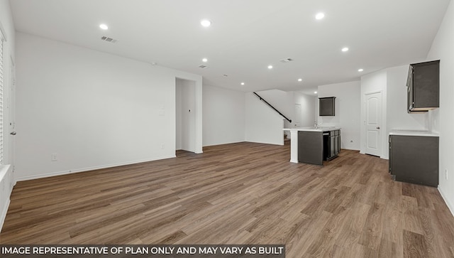 unfurnished living room with wood-type flooring