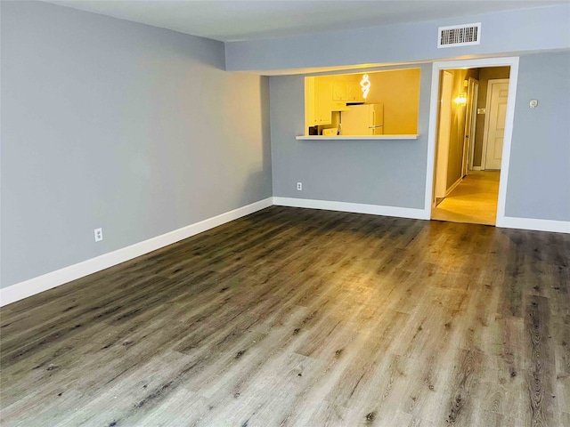 empty room with hardwood / wood-style flooring