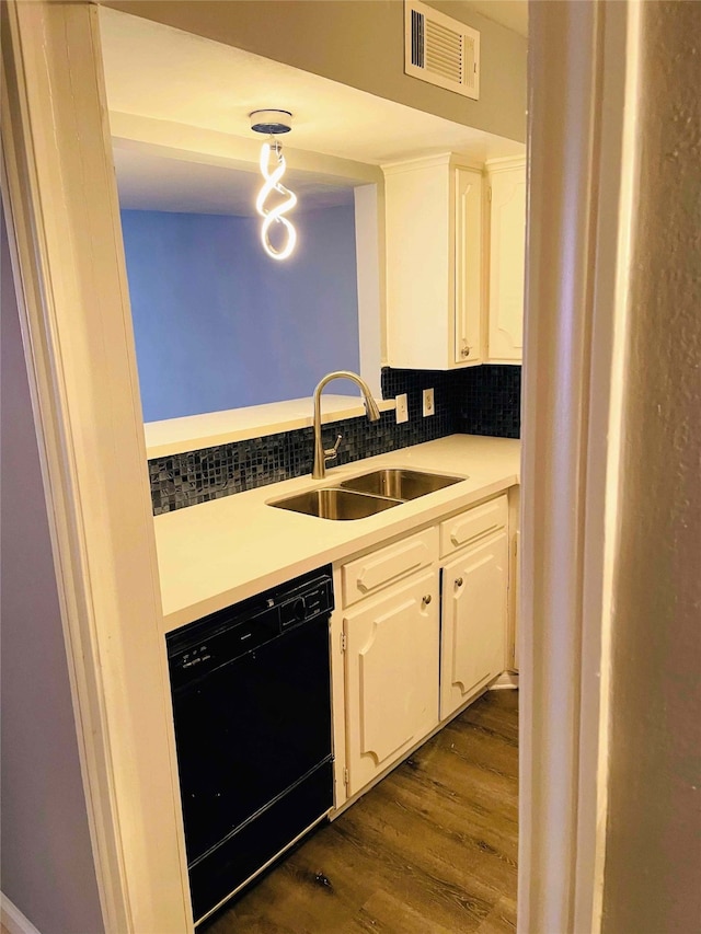 kitchen featuring white cabinets, sink, decorative backsplash, black dishwasher, and dark hardwood / wood-style flooring