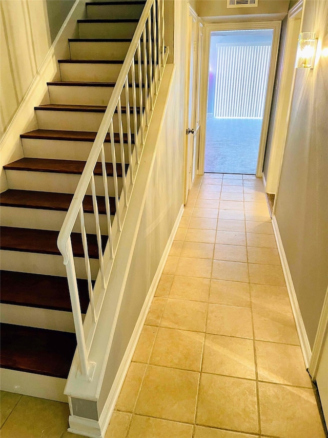 stairs featuring tile patterned floors