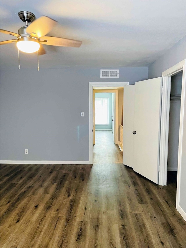 spare room featuring ceiling fan and dark hardwood / wood-style floors