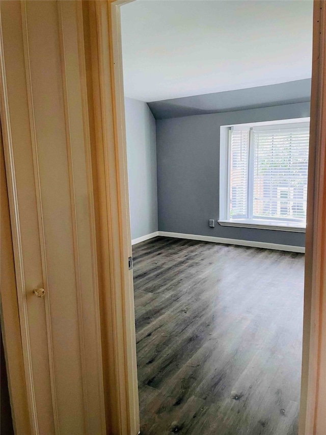 empty room with dark hardwood / wood-style flooring