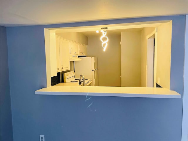 kitchen featuring white cabinets and white appliances