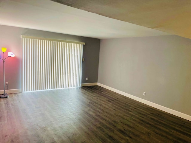 unfurnished room with dark hardwood / wood-style flooring