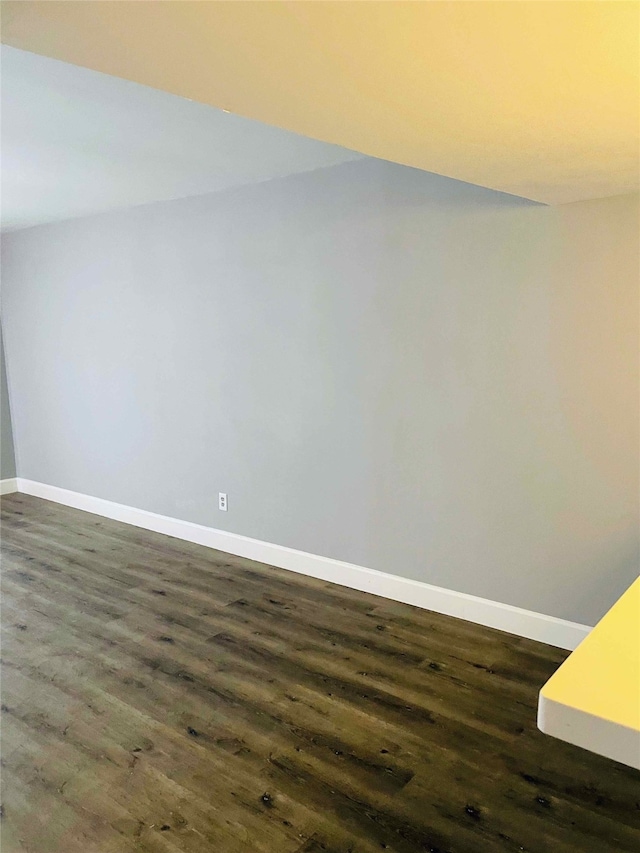 unfurnished room with dark hardwood / wood-style floors