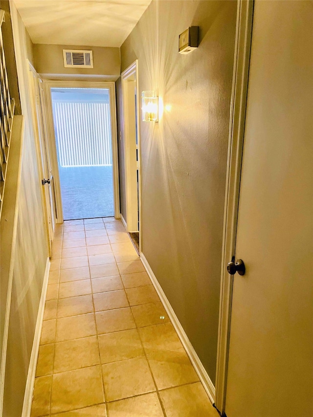 corridor featuring light tile patterned floors